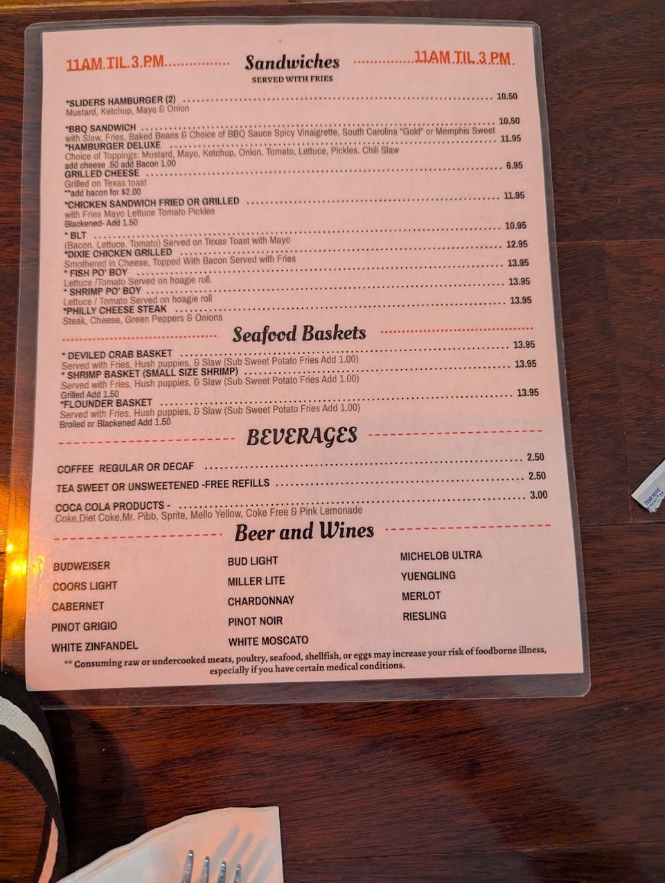 Menu board with seafood baskets and sandwiches.